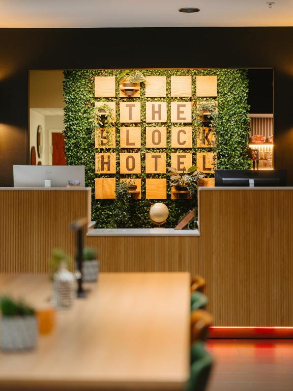 a wall with a mural of a building at The Block Hotel Bentonville in Bentonville
