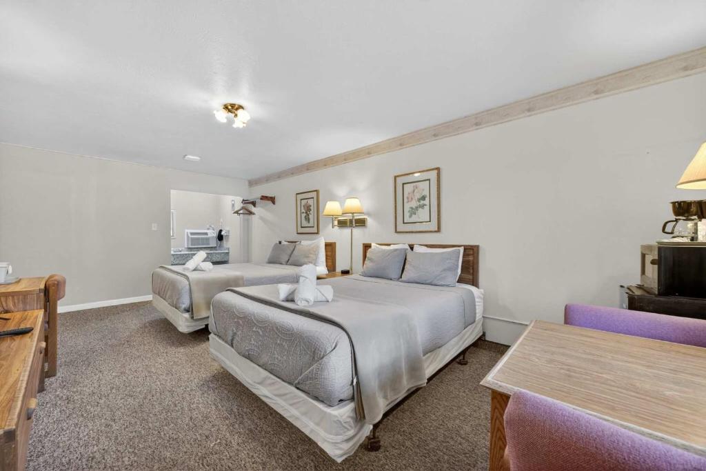 a hotel room with two beds and a couch at Eagle Motel Suite 112 in Manitou Springs