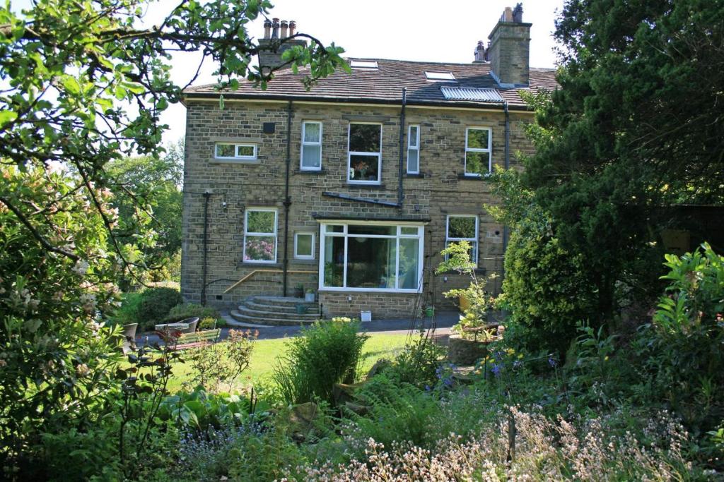 an old brick house with a garden in front of it at 2 Bed in Shepley oc-c36884 in Shepley