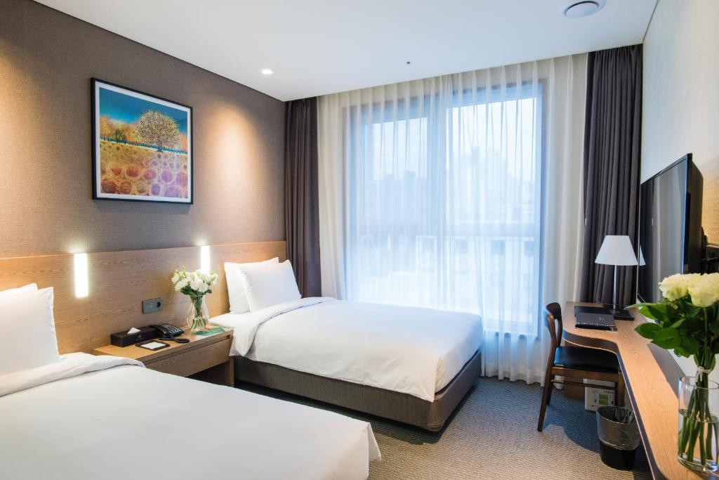 Postel nebo postele na pokoji v ubytování IBC Hotel Dongdaemun
