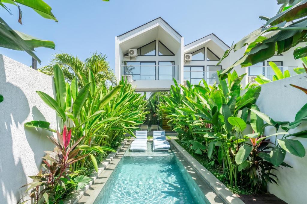 an exterior view of a villa with a swimming pool at U Villas - Tropical Views Luxury Stay with Pool & Workspace in Ungasan