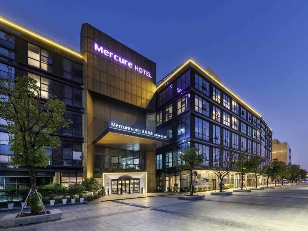 a large building with a sign on the front of it at Mercure Suzhou Downtown in Suzhou
