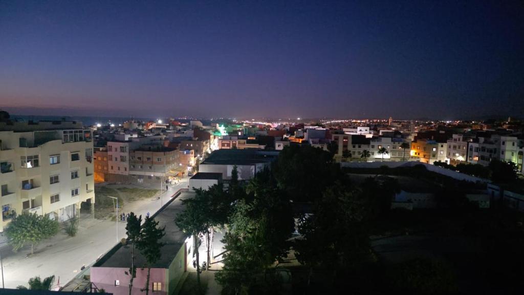 a view of a city at night with lights at Dar D'Asilah in Asilah