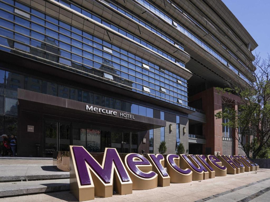 a large building with a mexico sign in front of it at Mercure Panjin in Panjin