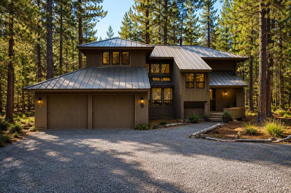 a house with a garage in the woods at Rock Ridge 009 in Black Butte Ranch