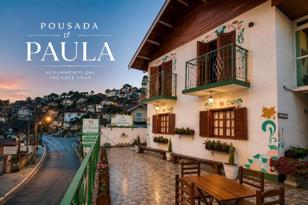 a poster for pula with a view of a building at Pousada D' Paula in Campos do Jordão