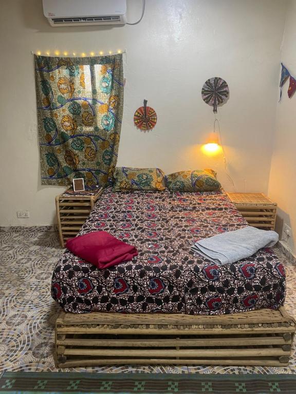 a bedroom with a bed with pillows on it at Marysa Lodge in Kotu