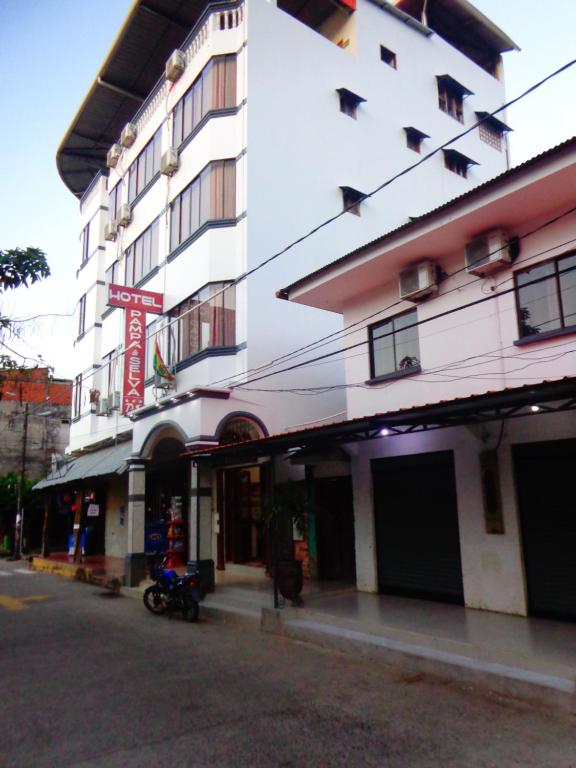 a building with a motorcycle parked in front of it at Pampa & Selva in Rurrenabaque