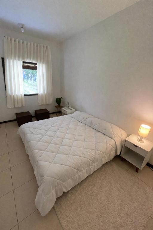 a bedroom with a large white bed in a room at Areal in Areal