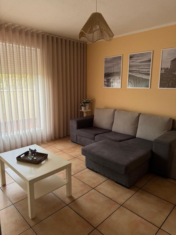 a living room with a couch and a coffee table at Ofir Guest House in Fão