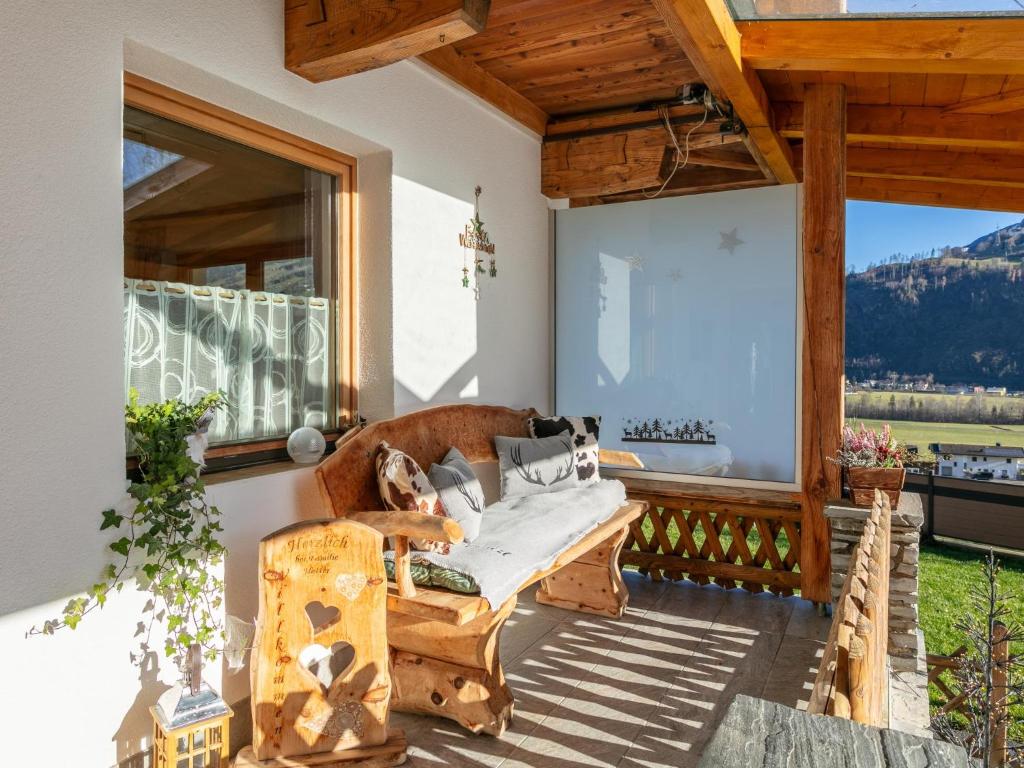 a living room with a couch on a porch with windows at Apartment Birgit in Zellberg