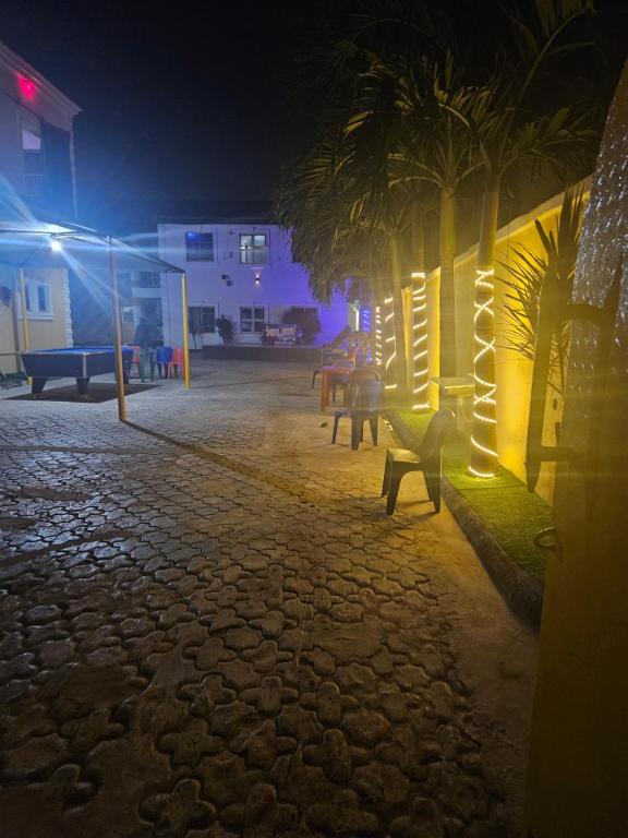 a park at night with benches and lights at The Maison Lodge in Ijegun