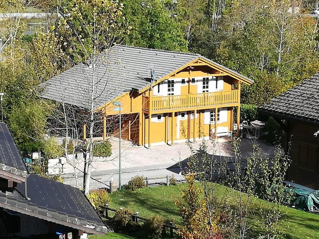 an overhead view of a yellow house with a yard at Le Temps-Passe in Saint-Jean-d'Aulps