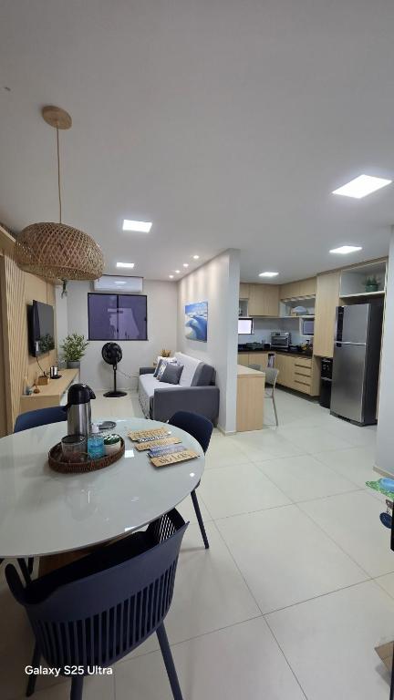 a living room with a couch and a table at Refúgio à Beira-Rio em Condomínio Exclusivo in Barreirinhas