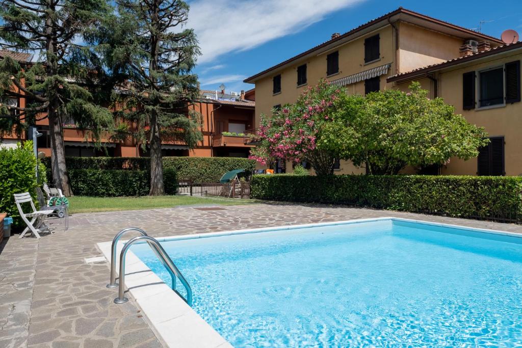 a swimming pool in front of a house at Casa Anna in Paratico