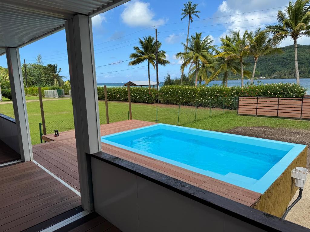 a swimming pool on the porch of a house at Villa Blue Lagoon Tahaa in Tahaa