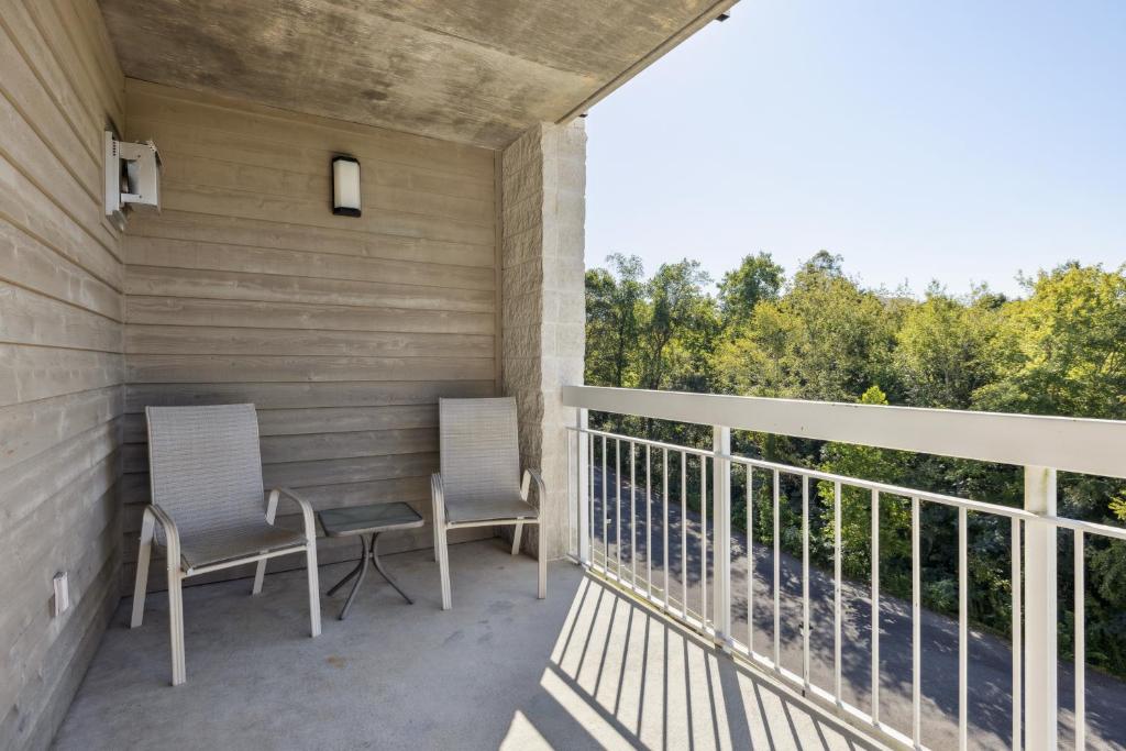 two chairs on a balcony with a view of trees at WP431 Private Sunsets in Pigeon Forge