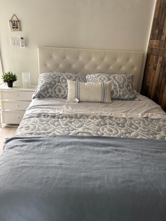 a bed with a blue comforter and pillows on it at dary hause in Indianapolis
