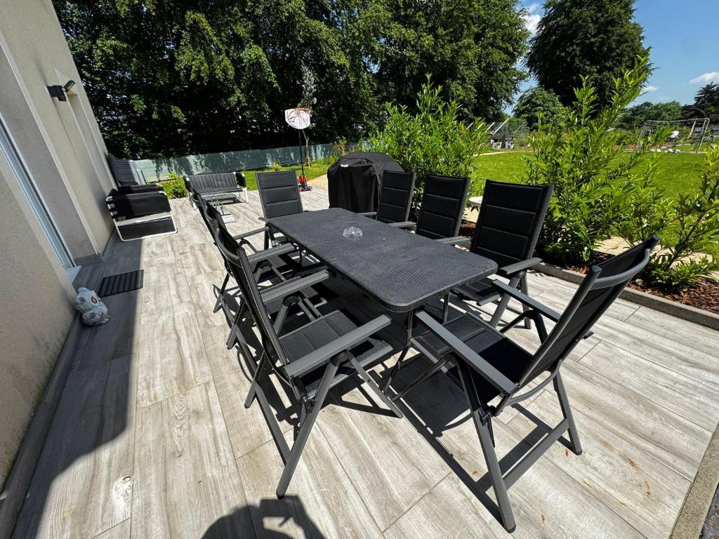 a table and chairs sitting on a deck at Zen House - Shopping at 3 min in Marnach