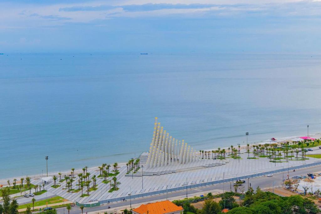 a view of a beach with a white bridge at The Sóng Infinity Pool Apartment Vung Tau Near Beach in Vung Tau