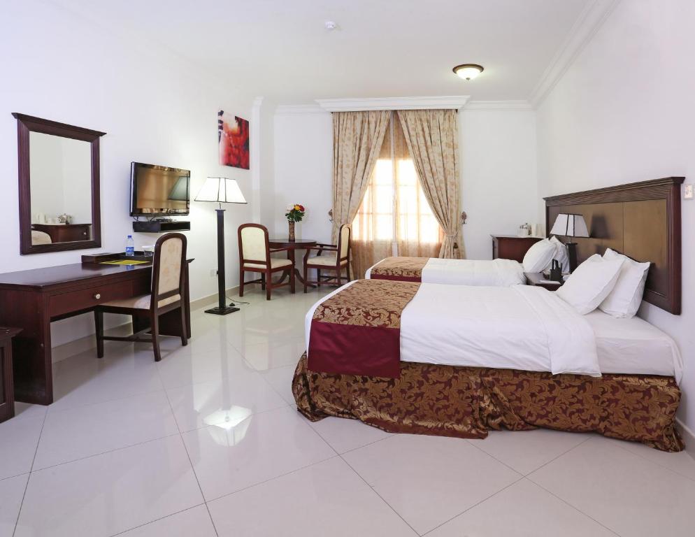 Postel nebo postele na pokoji v ubytování Al Maha Int Hotel Oman