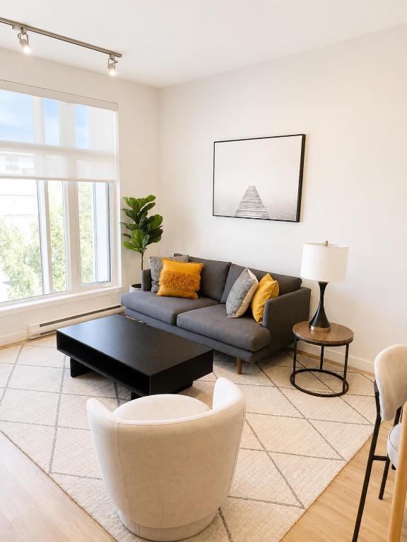a living room with a couch and a table at Lovely Brand New Suite in Sidney
