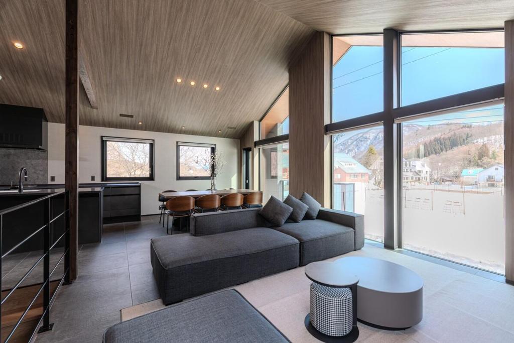 a living room with a couch and a table at Forest Resort Oak in Hakuba