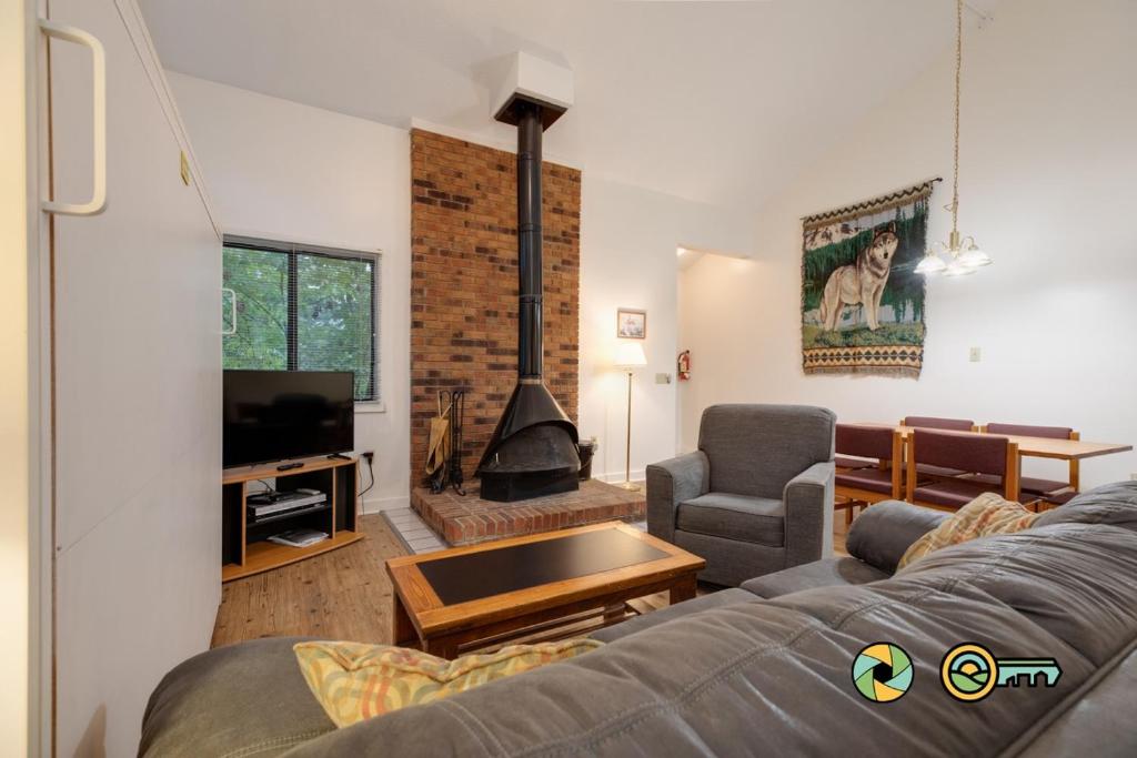 a living room with a couch and a fireplace at Senedo Springs Duplex #101A in Basye
