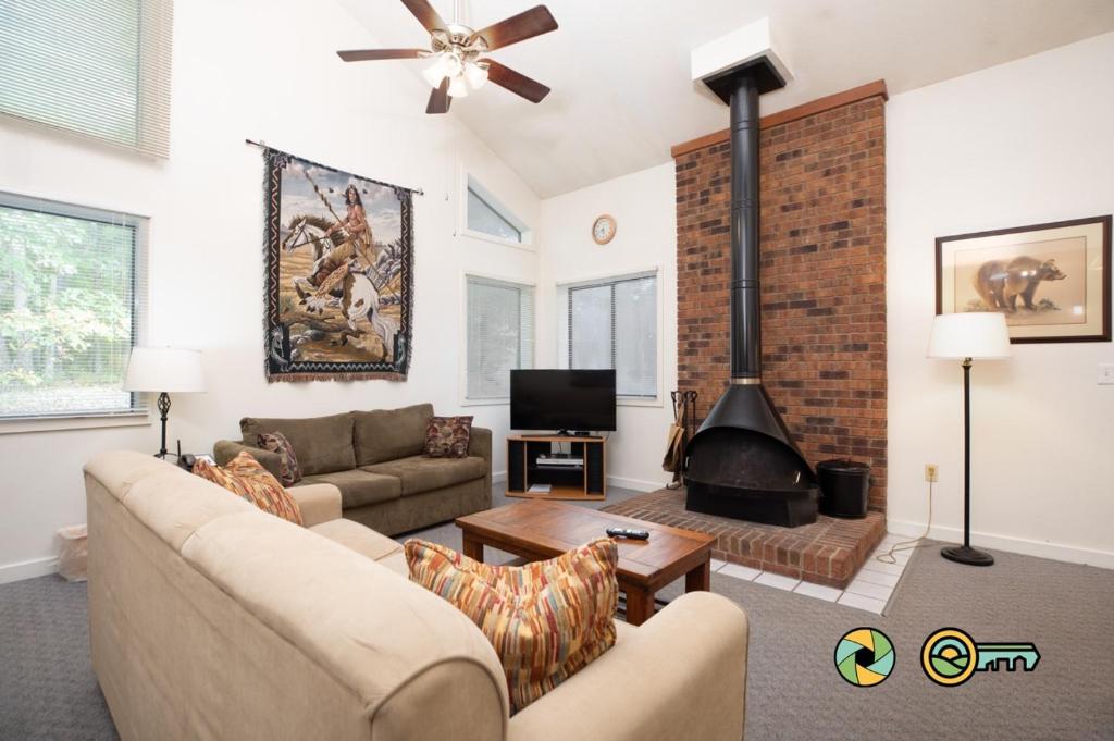 a living room with a couch and a fireplace at Senedo Springs Duplex #97A in Basye