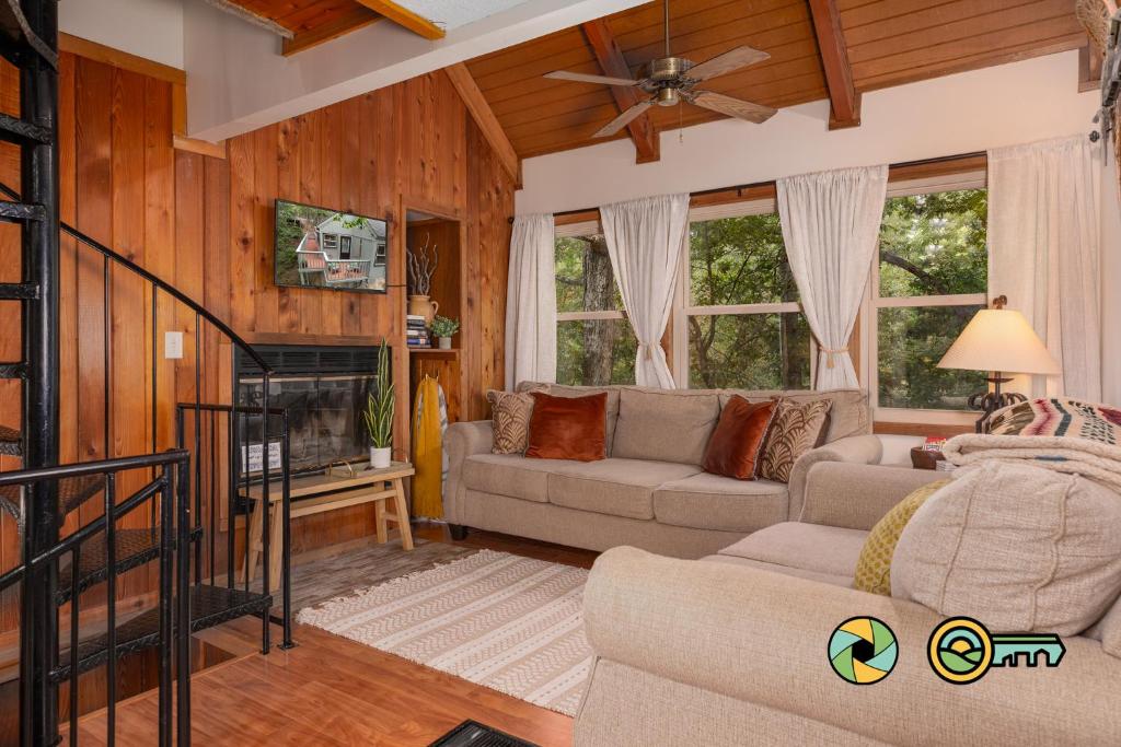 a living room with a couch and a fireplace at Lakeview 85B: Treehouse Mountain in Basye