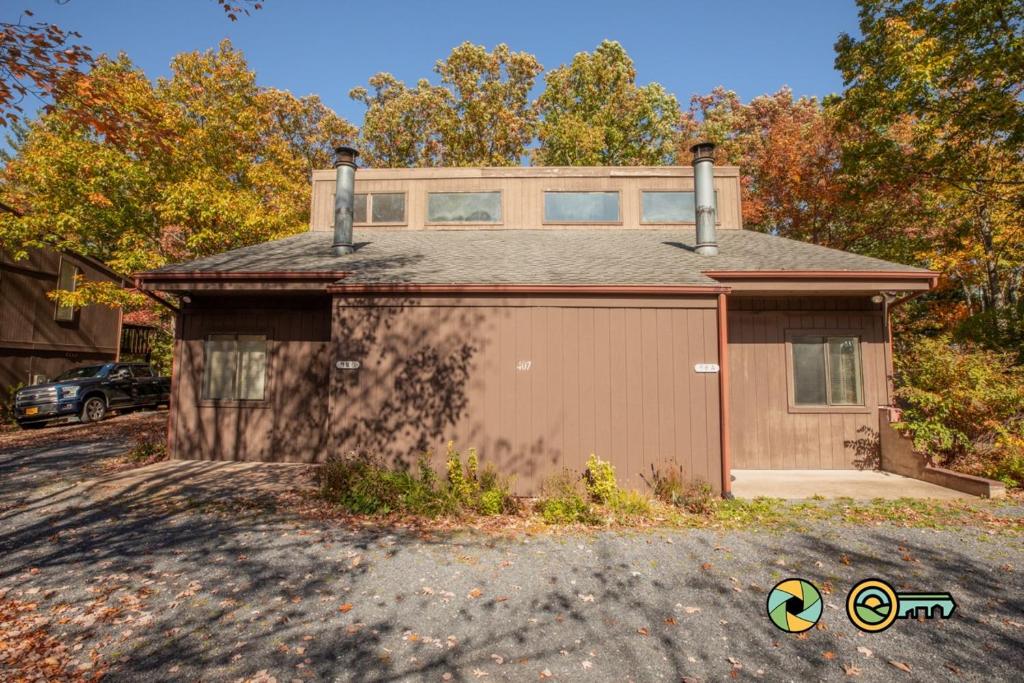 a house with a garage in front of it at Senedo Springs Duplex #98B in Basye