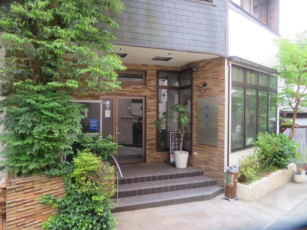 an entrance to a building with stairs and plants at Hakone Miyanoshita Myojokan in Hakone