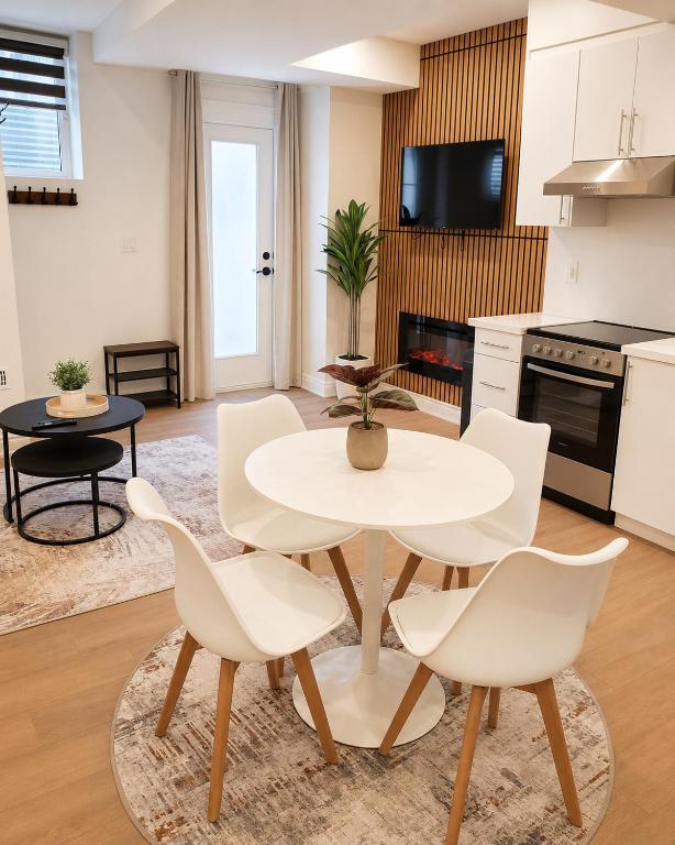 a living room with a white table and chairs at New 2BR Central AC Laundry Private Entry Parking in Milton