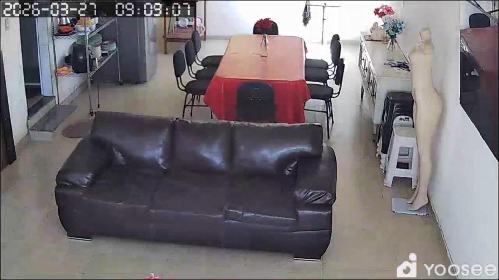 a table and a leather couch in a room with chairs at Casa branca in Aracaju