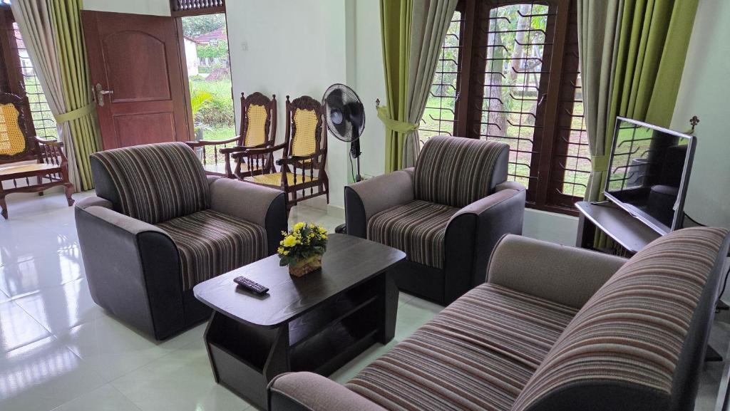 a living room with two couches and a tv at Bopitiya Residence 20 Mins from Airport in Bopitiya