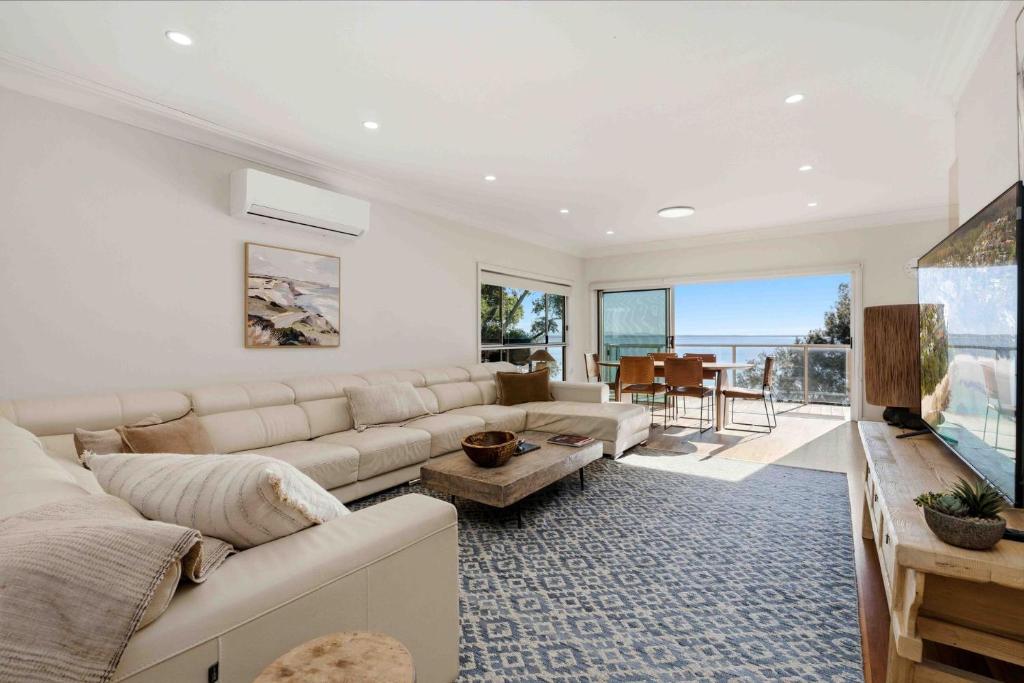 a living room with a couch and a table at Sunkissed & Studio in Vincentia