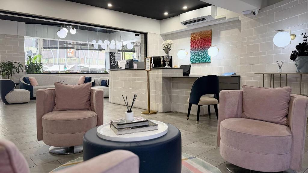 a waiting room with chairs and a table and a counter at The Metropolitan Spring Hill in Brisbane