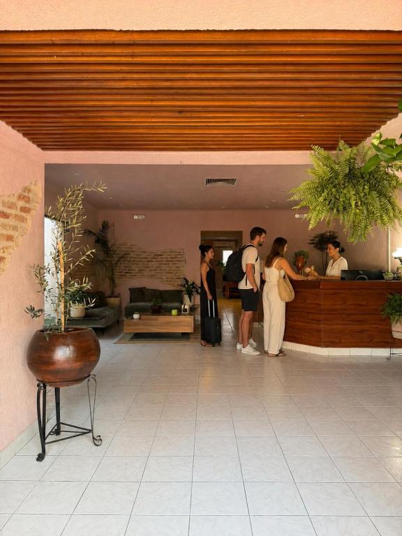 a group of people standing in a lobby at Hostal Punto Americana in Guadalajara