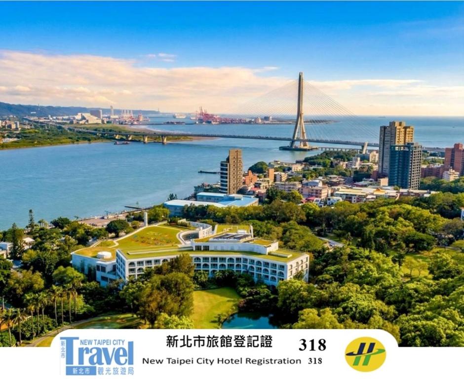 a view of a city with a river and a bridge at Golden Tulip FAB Hotel New Taipei in Tamsui