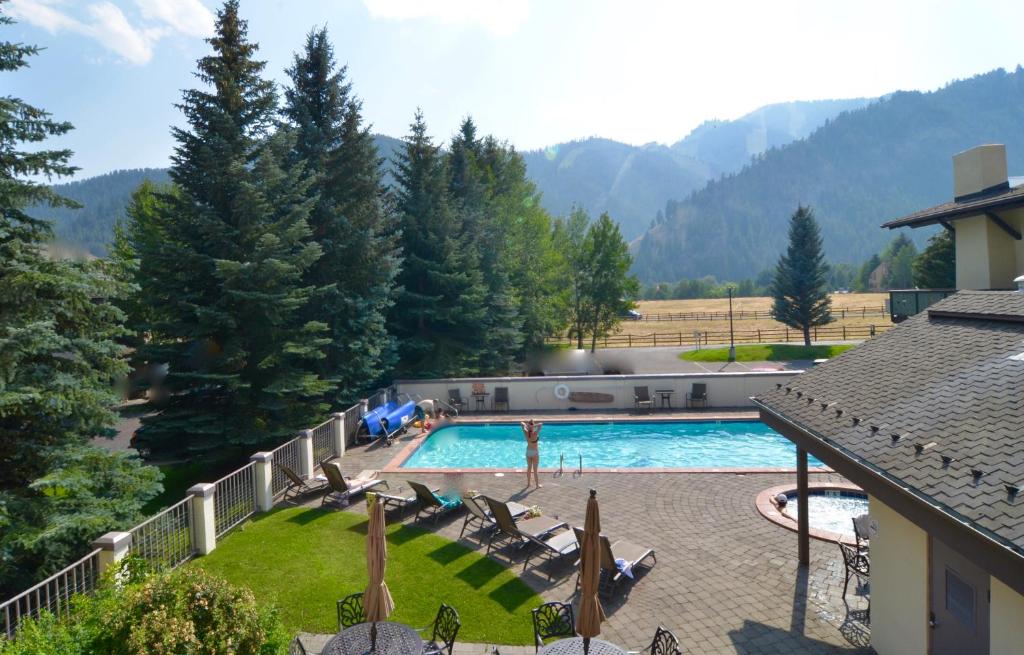 a view of a swimming pool with mountains in the background at Sun Valley Adventures Heated Pool & Spa in Ketchum