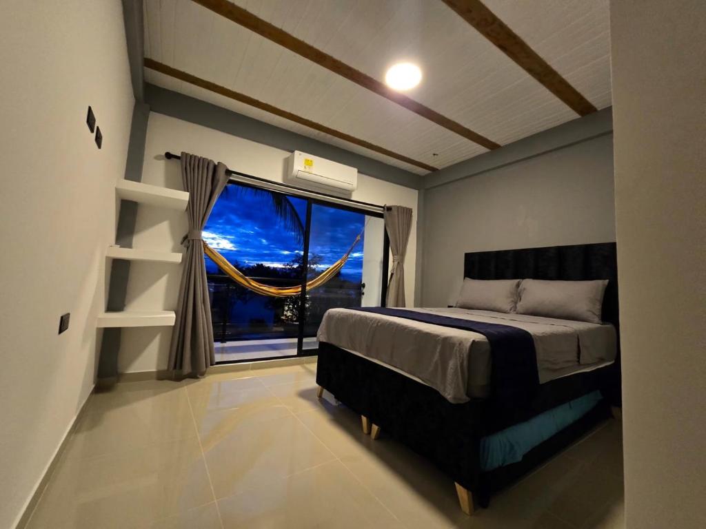 a bedroom with a bed and a large window at Villa Yasmin in Prado