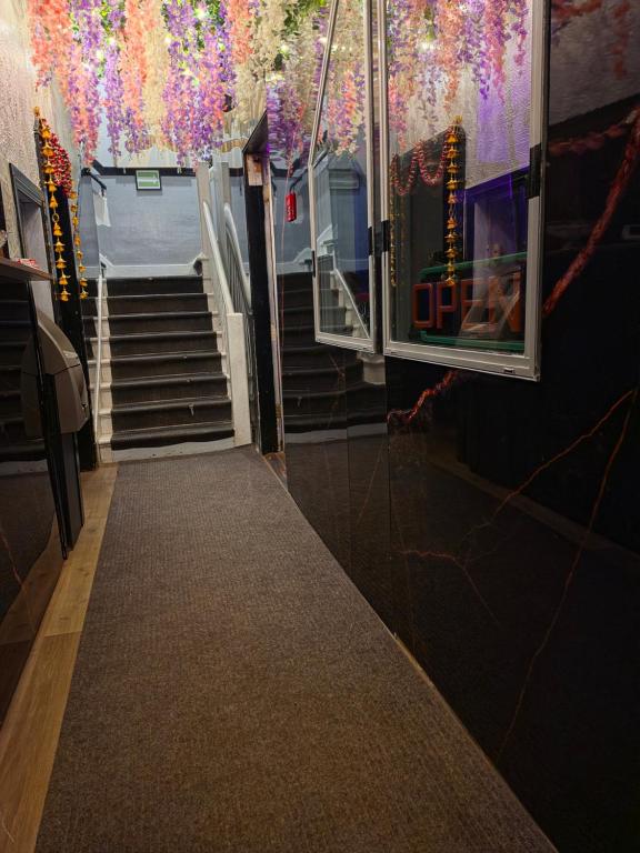 a hallway with stairs and colorful decorations on the wall at Dinosaur Hotel in Drumheller