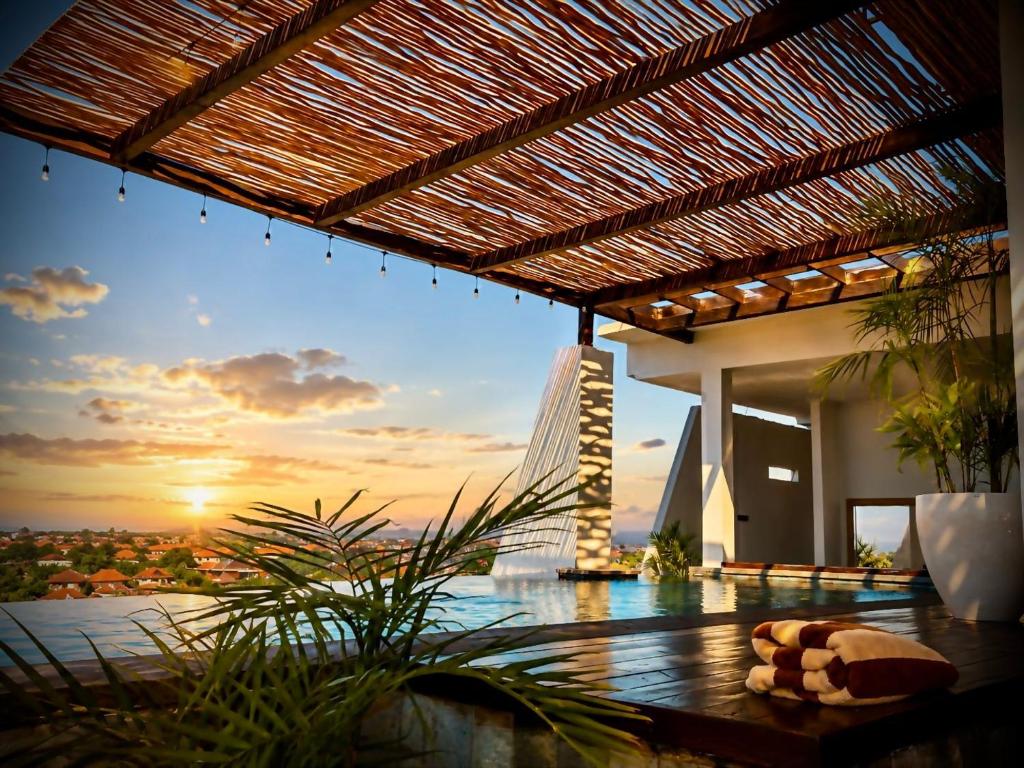 a view of the sunset from a house at The Kayangan Sanur in Sanur