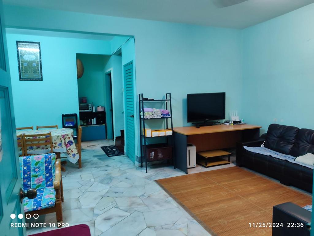 a living room with a couch and a television at Homestay Dasuqi #Musl!m only in Seremban