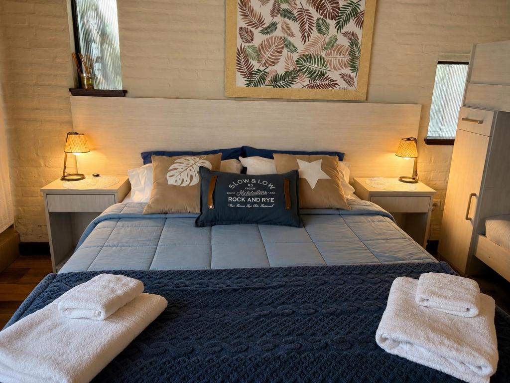 a bedroom with a bed with two towels on it at Apart Los Cerrillos in Balcarce