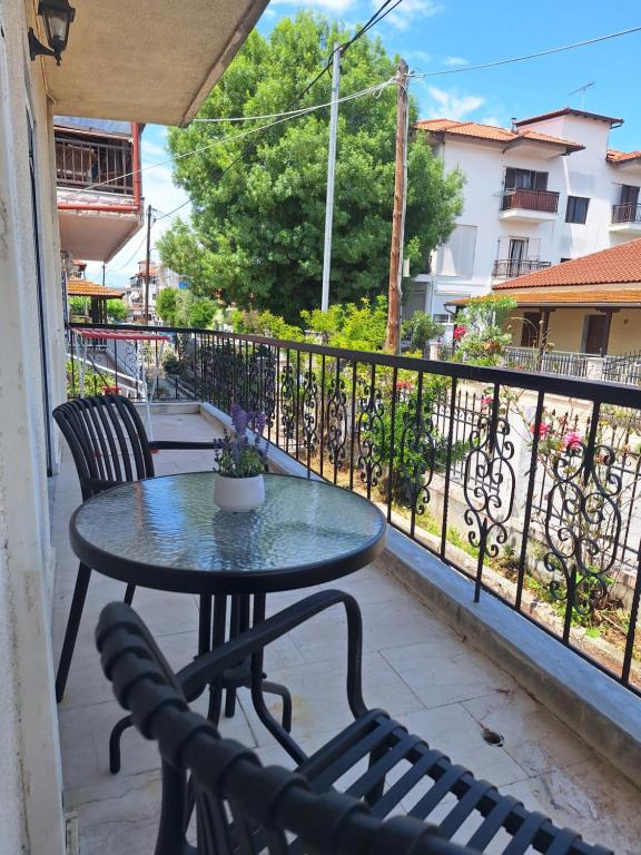 a patio with a table and chairs on a balcony at Casa Patronimio Aristotle Socrates Residence in Ierissos