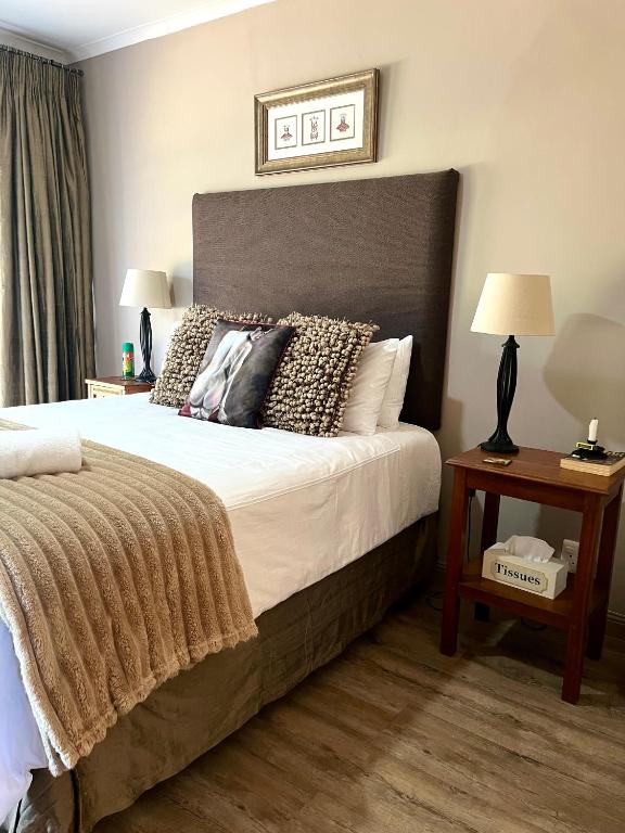 a bedroom with a large bed with pillows on it at Makiti Retreat in Polokwane