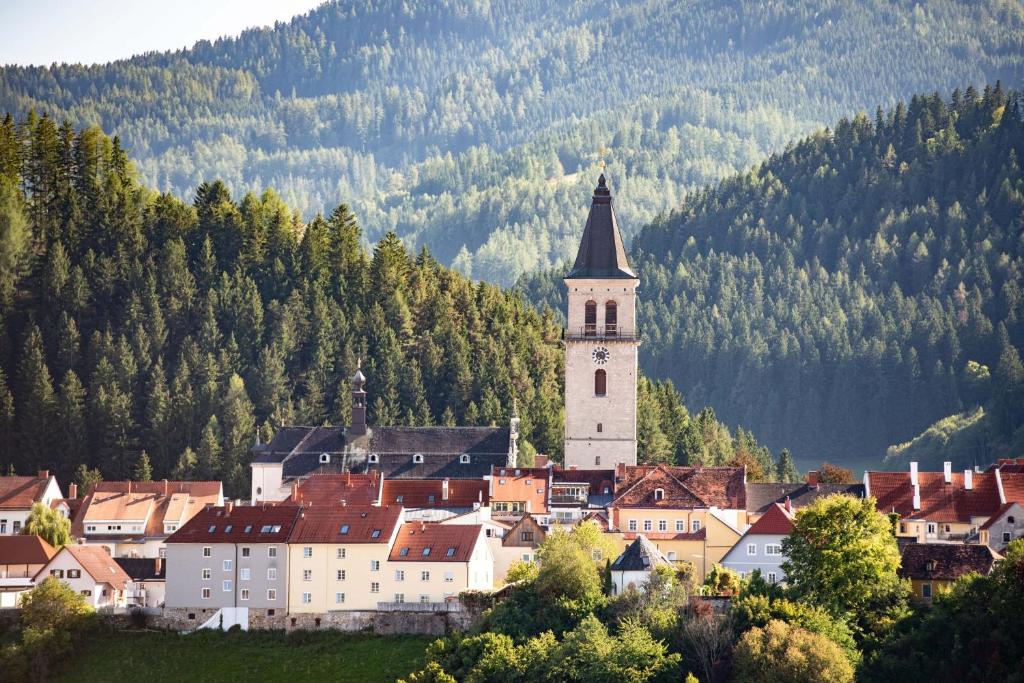 a small town with a church and a mountain at Thomas in Judenburg