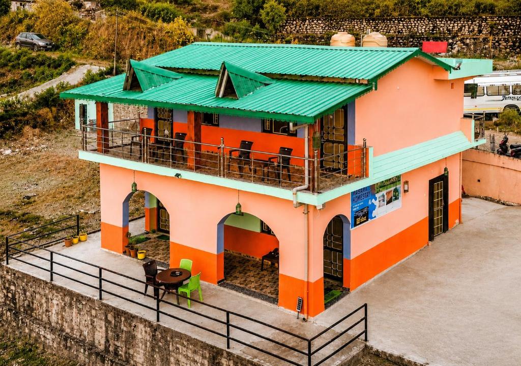 a house with a green roof and a balcony at Aasara Homestay Bhimtal Orchard Villa in Bhīm Tāl