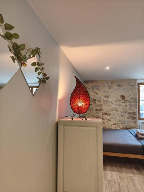 a lamp sitting on top of a table in a room at L'aube de Pierre in Saint-Pons-de-Thomières